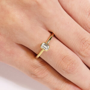 18ct yellow gold 0.30ct FG VS emerald cut diamond bezel set solitaire ring